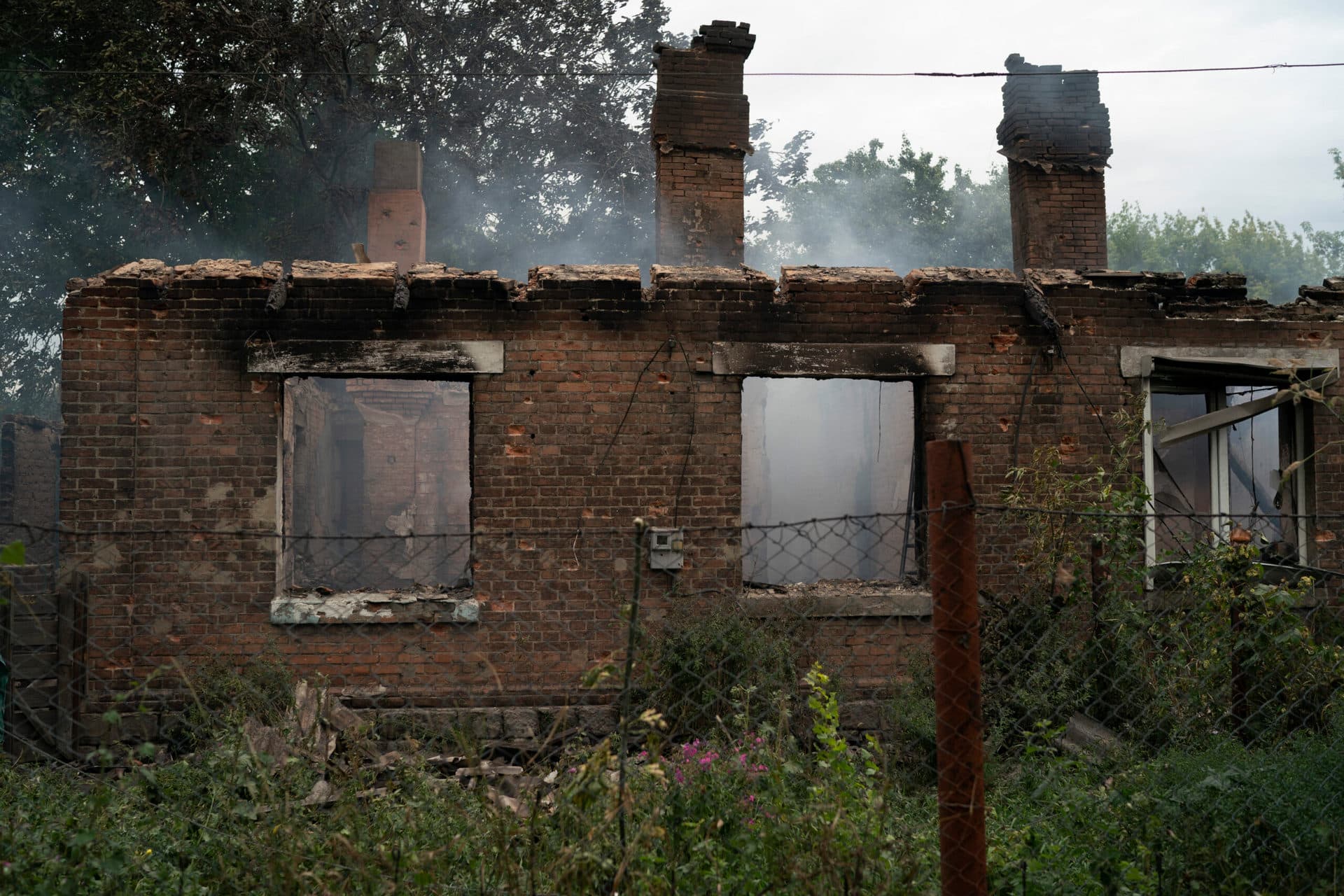 Smoke rise from a house that was heavily damaged after a Russian attack in Pokrovsk region