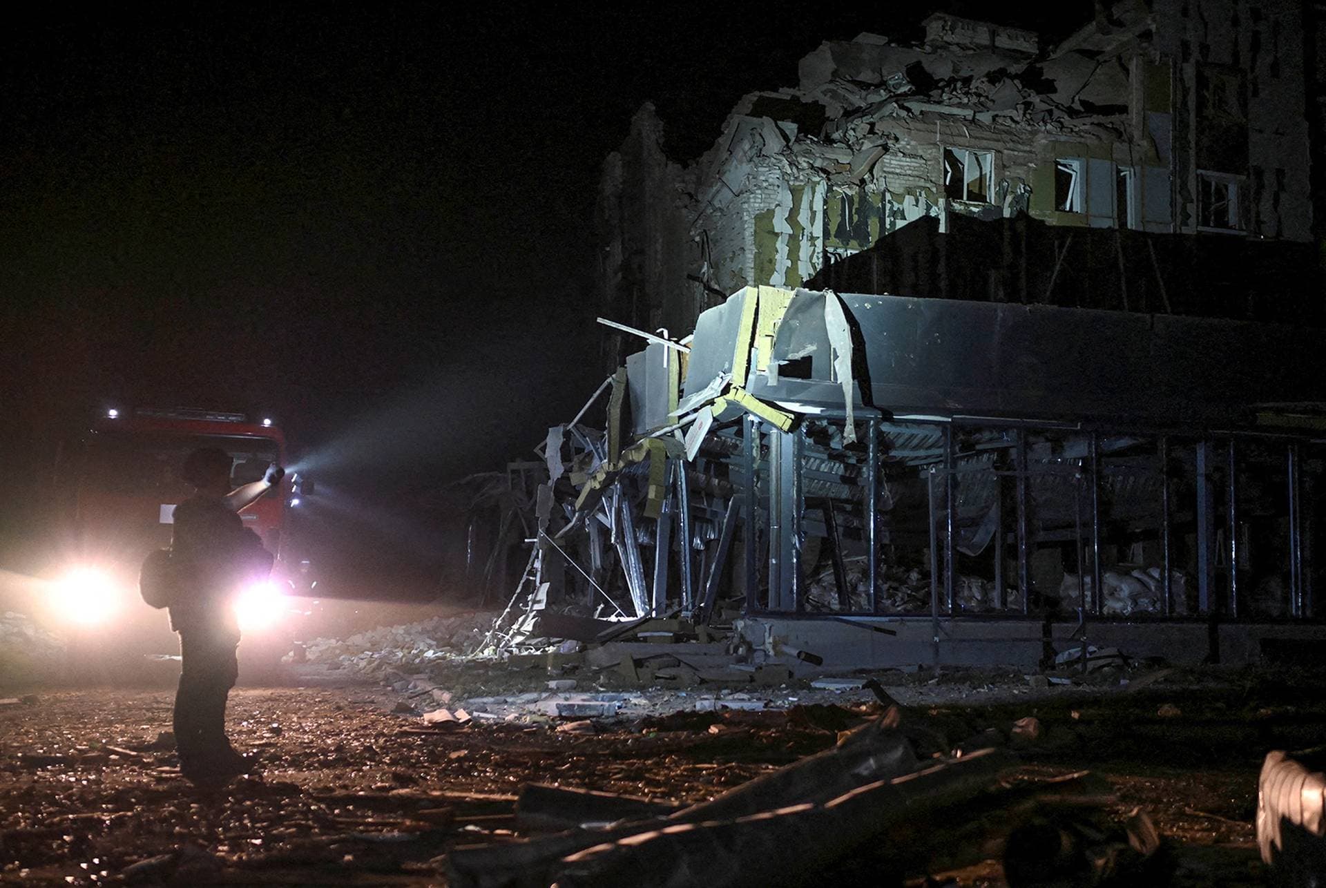 Rescuers work at the site of a building destroyed during a Russian missile strike in Pokrovsk