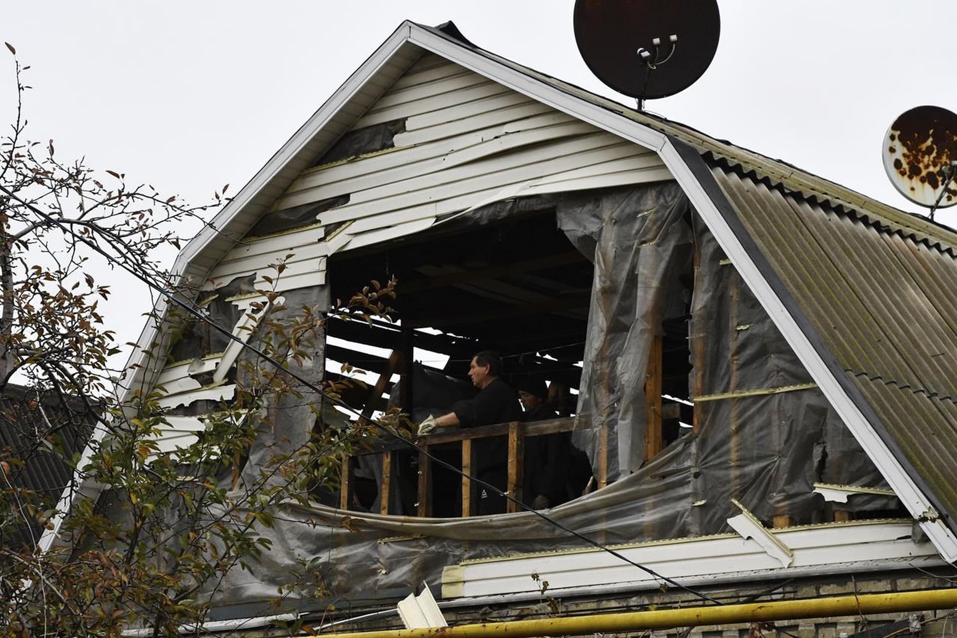A man looks for non-destroyed belongings inside his house in Pokrovsk