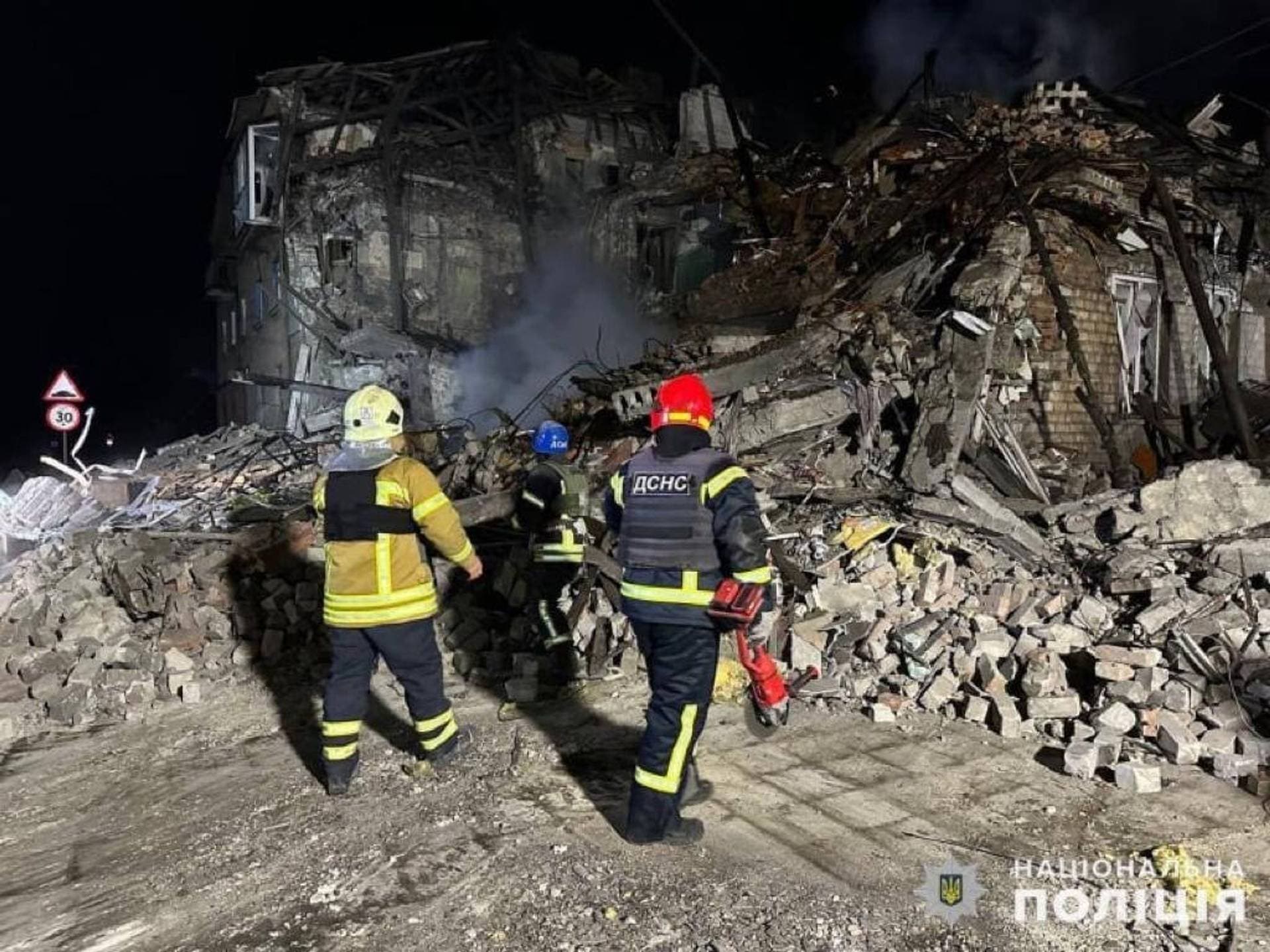 Rescuers work at the scene of a building damaged by shelling in Pokrovsk