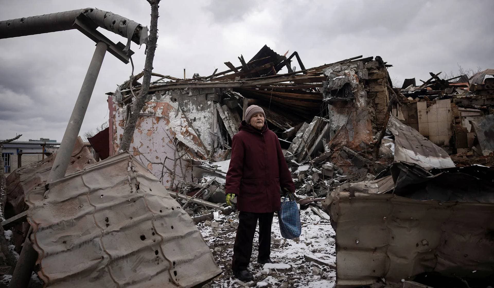 Nadezhda Prokopenko stands in front of the house of a relative that was destroyed in a Russian missile strike in Selydove