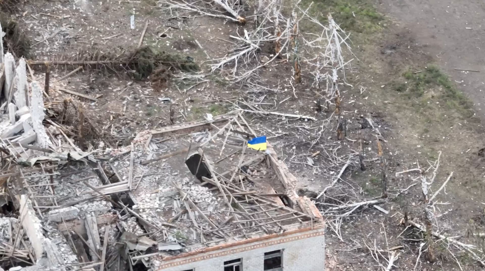 Ukrainian forces raise the national flag in the settlement of Robotyne