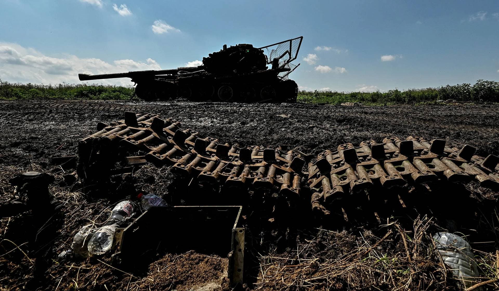 A Ukrainian serviceman inspects a destroyed Russian tank in the recently liberated village of Novodarivka