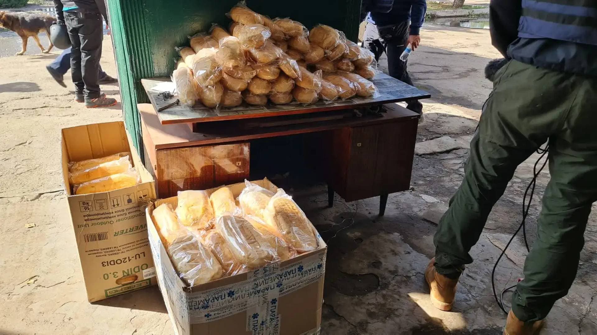 Aid workers deliver loaves of bread to the few Ukrainians who remain in Orikhiv