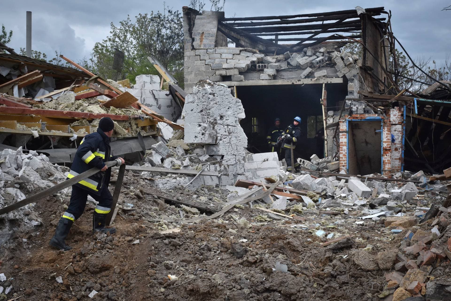 Ukrainian State Emergency Service firefighters put out fire after a Russian air raid hit apartment buildings in Orihiv