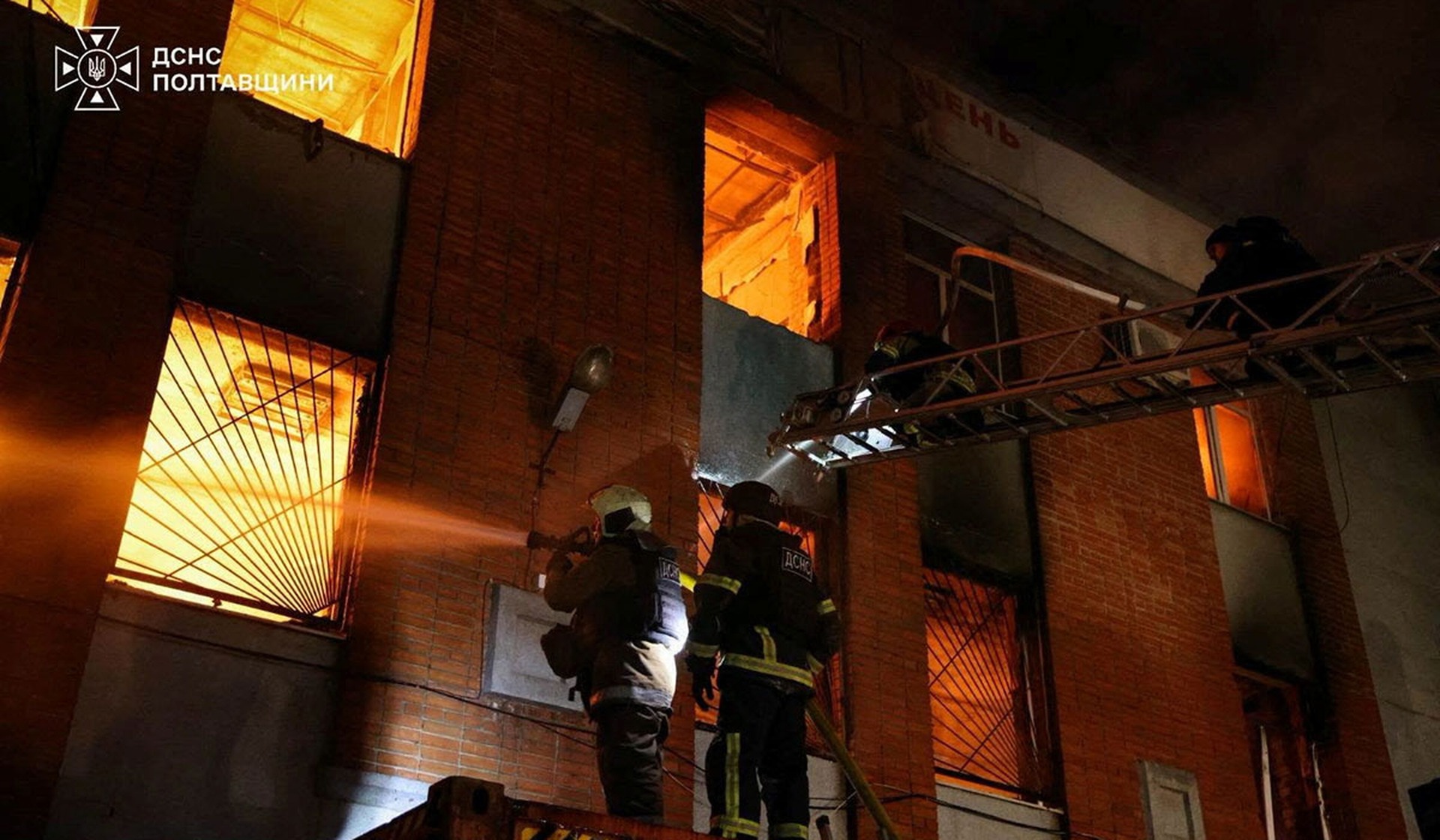 Firefighters work at the site of an administrative building damaged during an overnight Russian drone strike in Poltava
