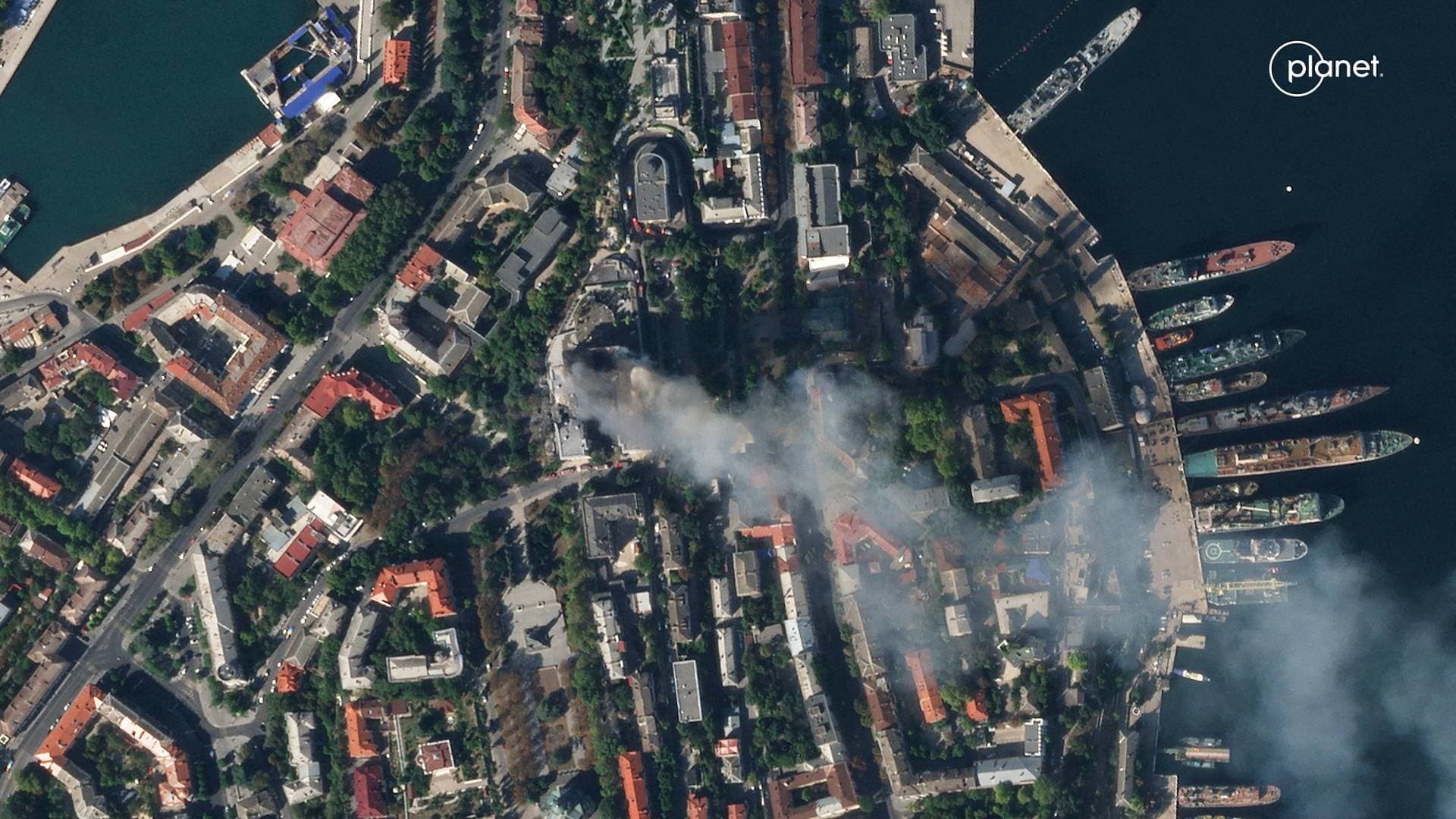A satellite image shows smoke billowing from the Russian Black Sea Navy HQ after a missile strike in Sevastopol