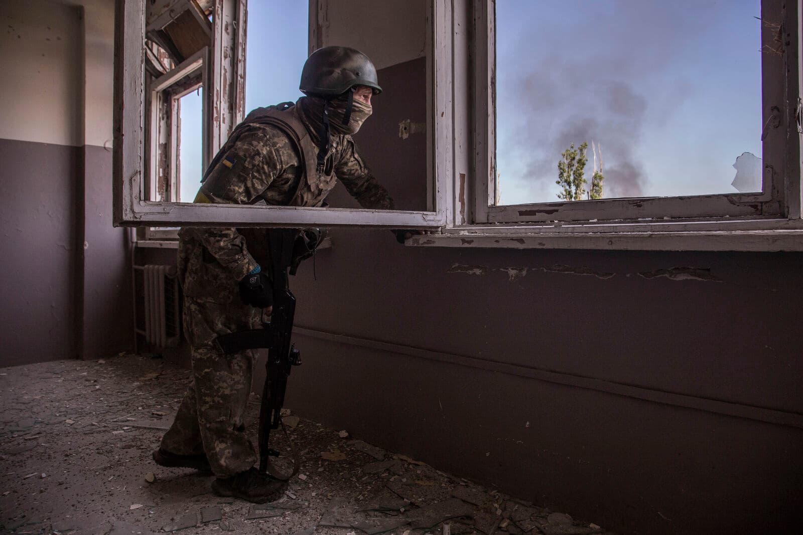 A Ukrainian soldier takes position during heavy battles at the front line in Severodonetsk