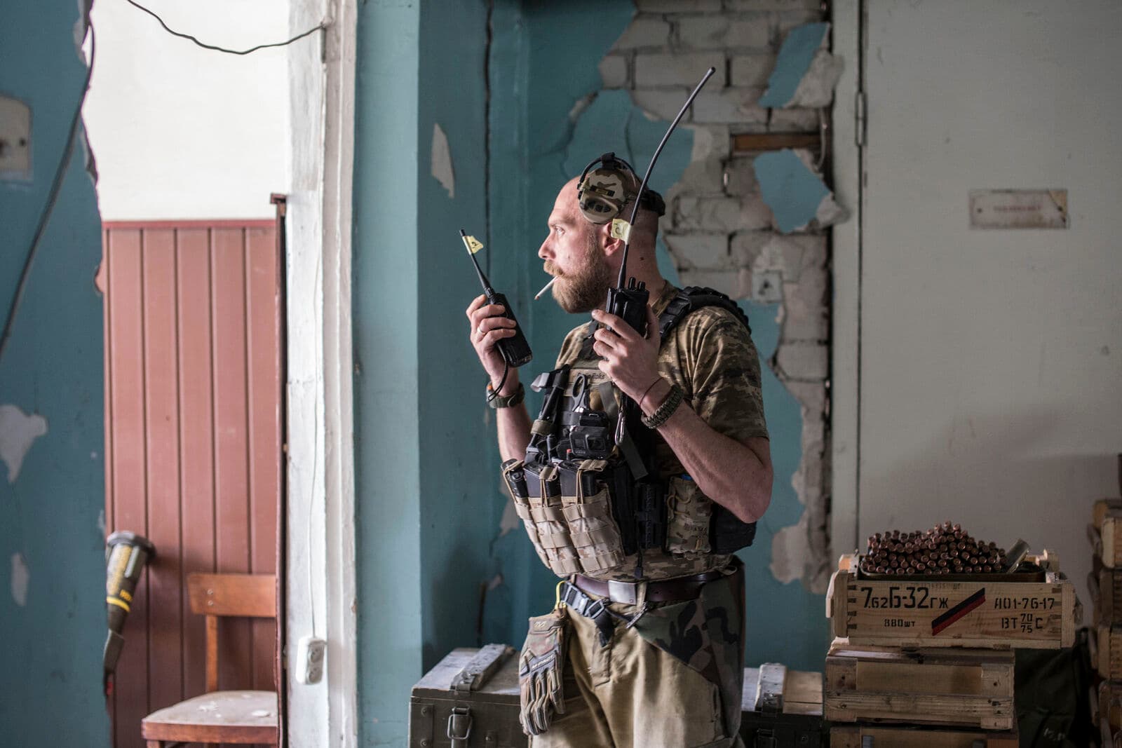 A Ukrainian soldier holds radios during heavy fighting on the front line in Severodonetsk