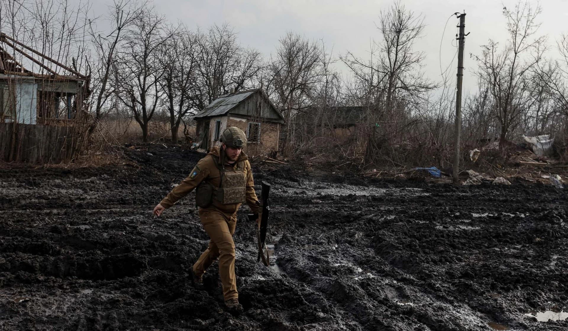 A Ukrainian serviceman walks on a street in a village near the frontline town of Kreminna