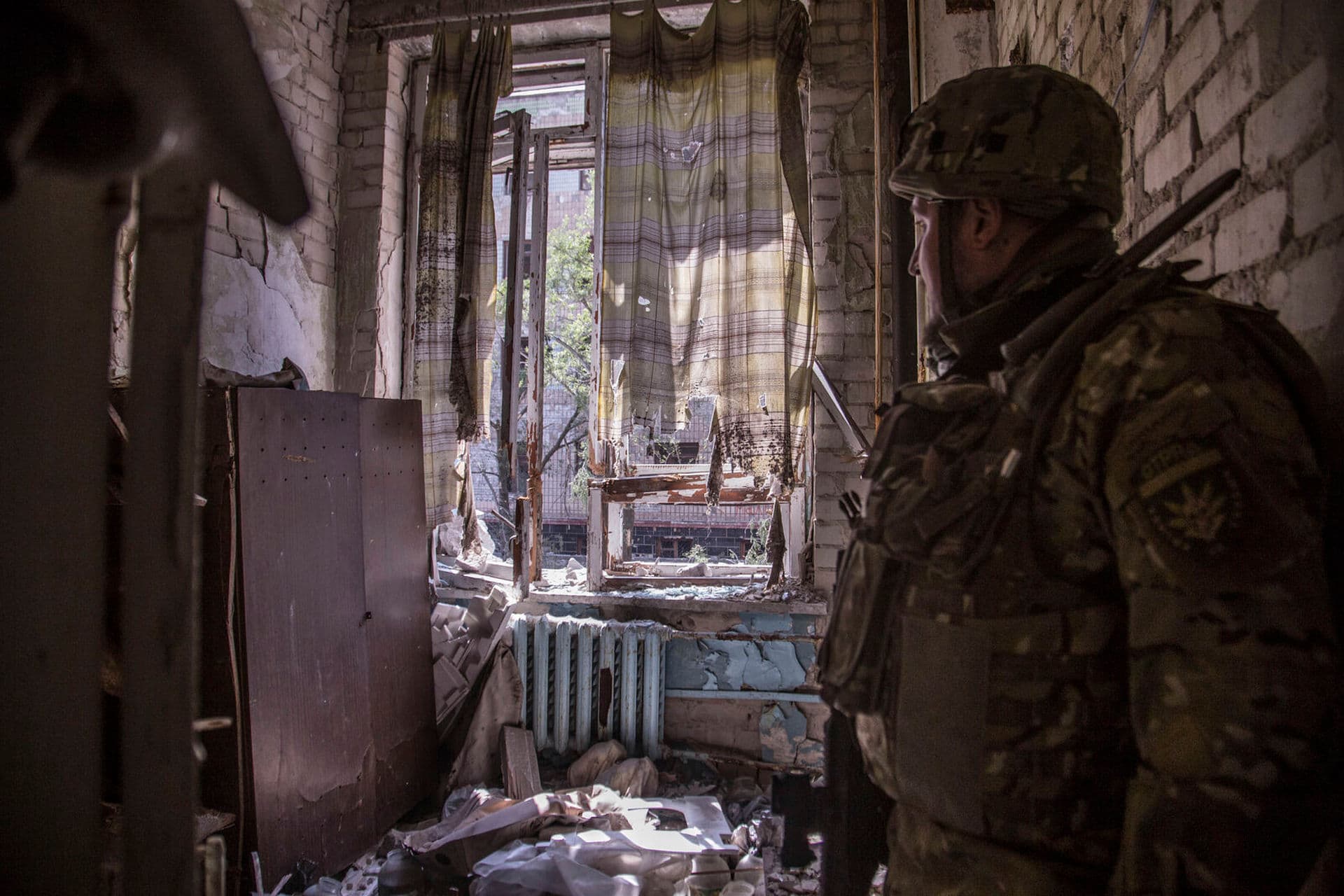 A Ukrainian soldier stands in a position during heavy fighting on the front line in Severodonetsk