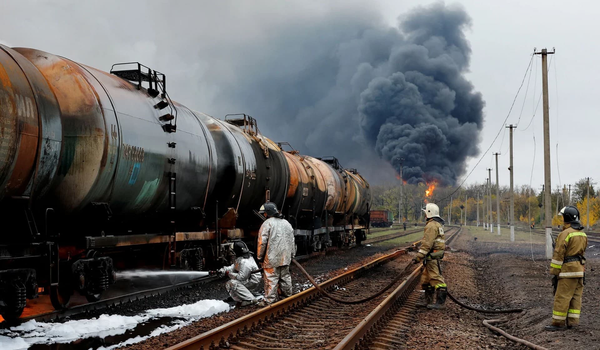 Firefighters work to extinguish fire following recent shelling at a railway junction in Shakhtarsk