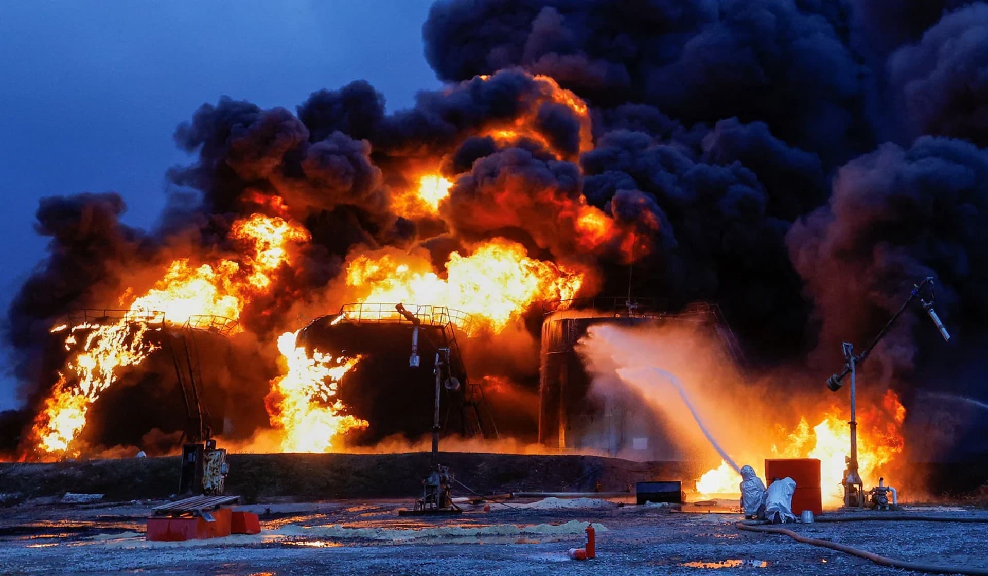 Firefighters work to extinguish fire following recent shelling at an oil storage facility in Shakhtarsk