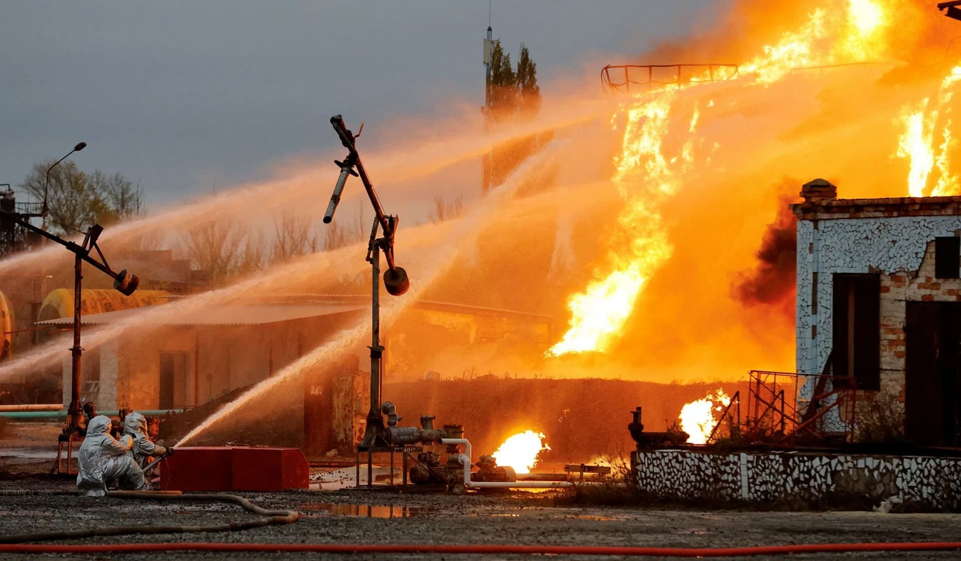 Firefighters work to extinguish fire following recent shelling at an oil storage facility in Shakhtarsk