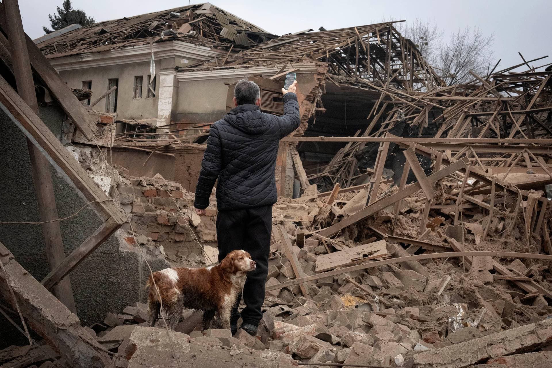 A resident looks at the remains of an industrial building after a Russian rocket attack in Sloviansk