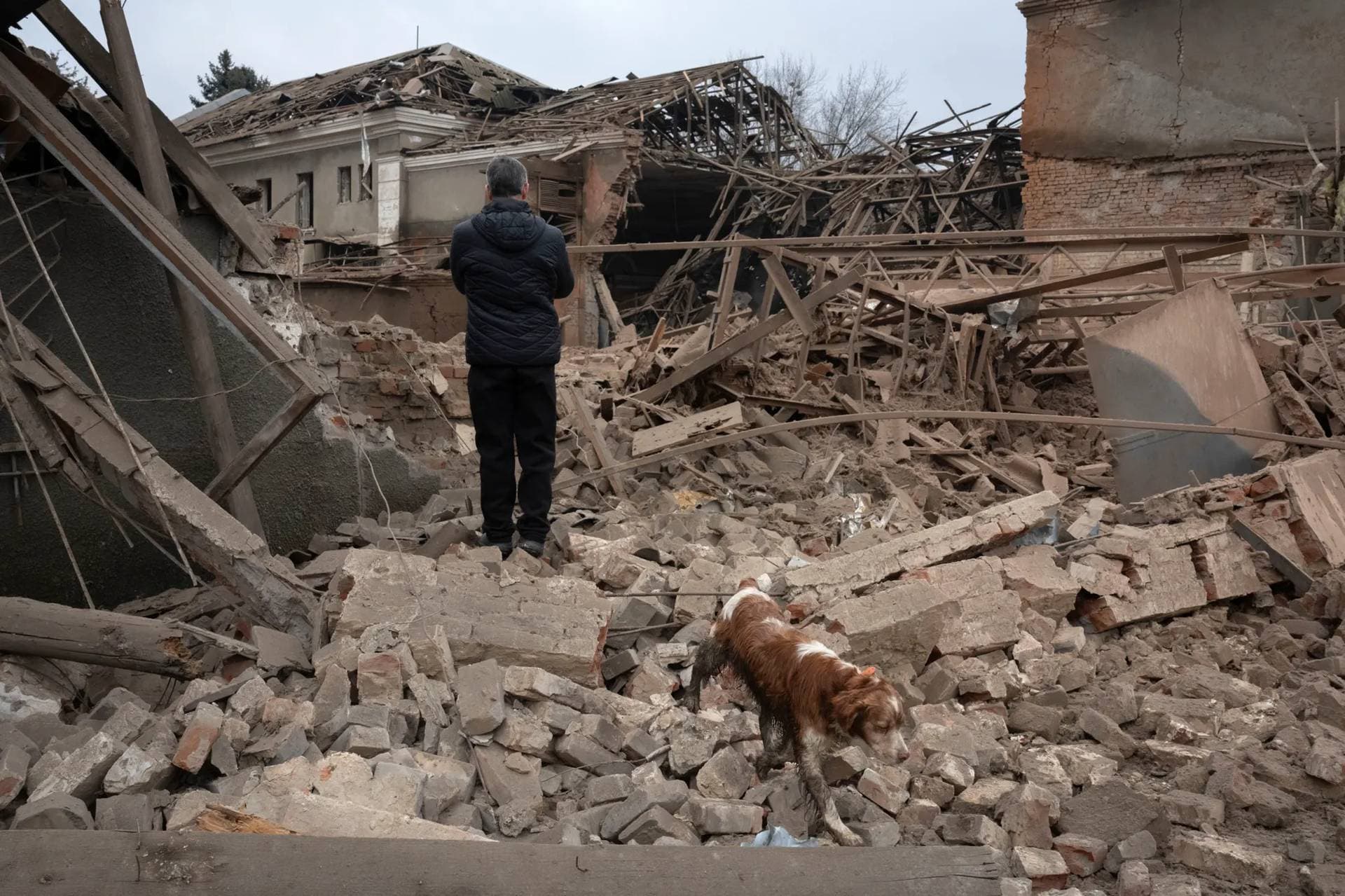 A resident looks at the remains of an industrial building after a Russian rocket attack in Sloviansk