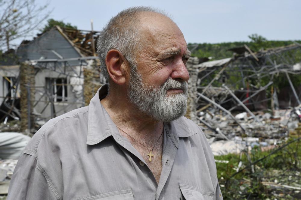 A man reacts as he stands next to a building damaged by an overnight missile strike in Sloviansk