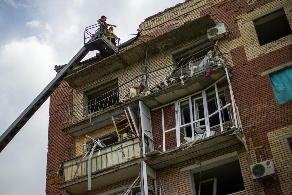 Rescue workers inspect an apartment building damaged in an overnight missile strike in Sloviansk