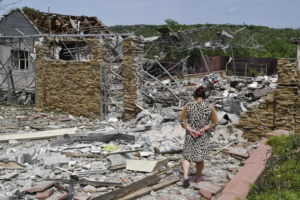 An elderly woman walks next to a building damaged by an overnight missile strike in Sloviansk