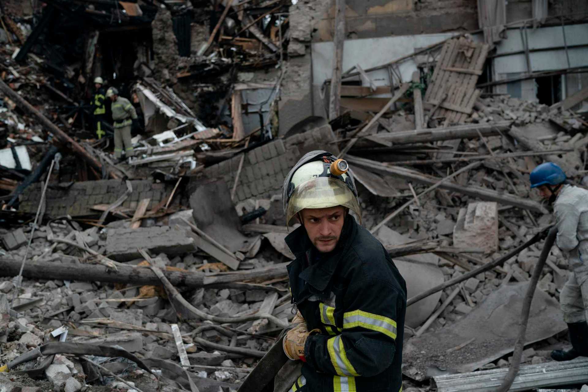 A firefighter works after a Russian attack that heavily damaged a building in Sloviansk