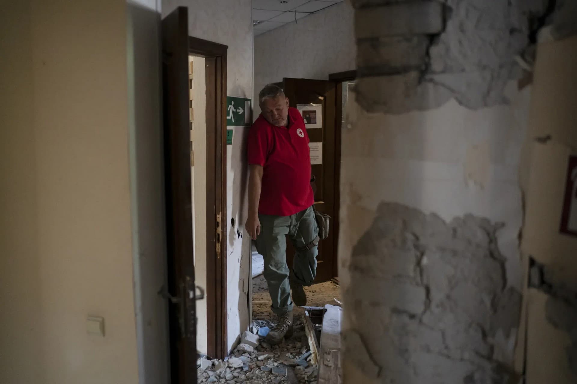 The head of the rapid response unit Taras Logginov walks in the damaged building of the Ukrainian Red Cross Society that was hit last week during a Russian attack in Sloviansk