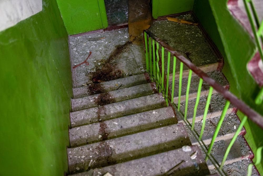 Blood stains mark the stairs inside a building damaged in an overnight missile strike in Sloviansk