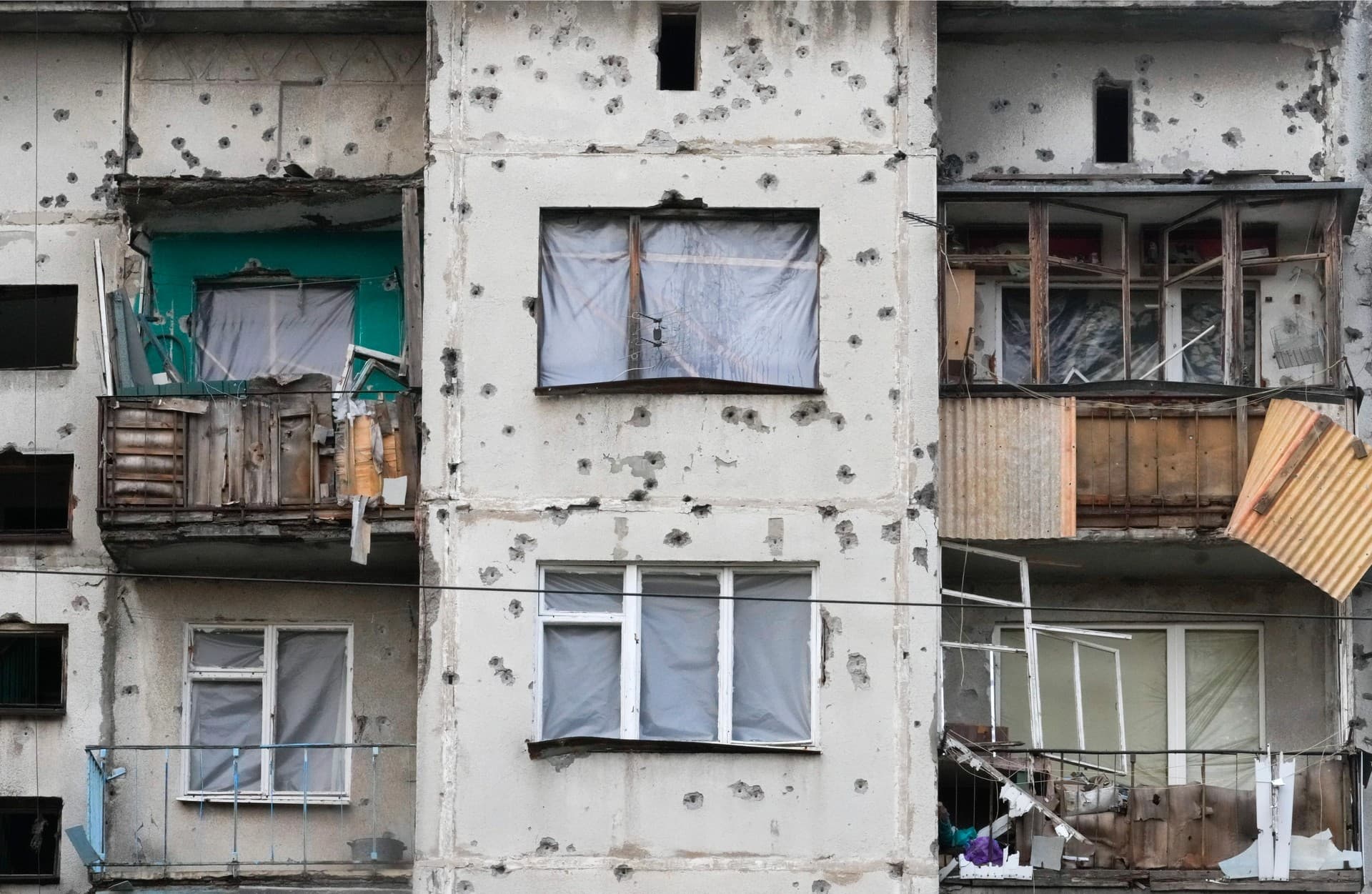 Traces of shrapnel from the Russian rockets cover a multi storey house in central Slavyansk