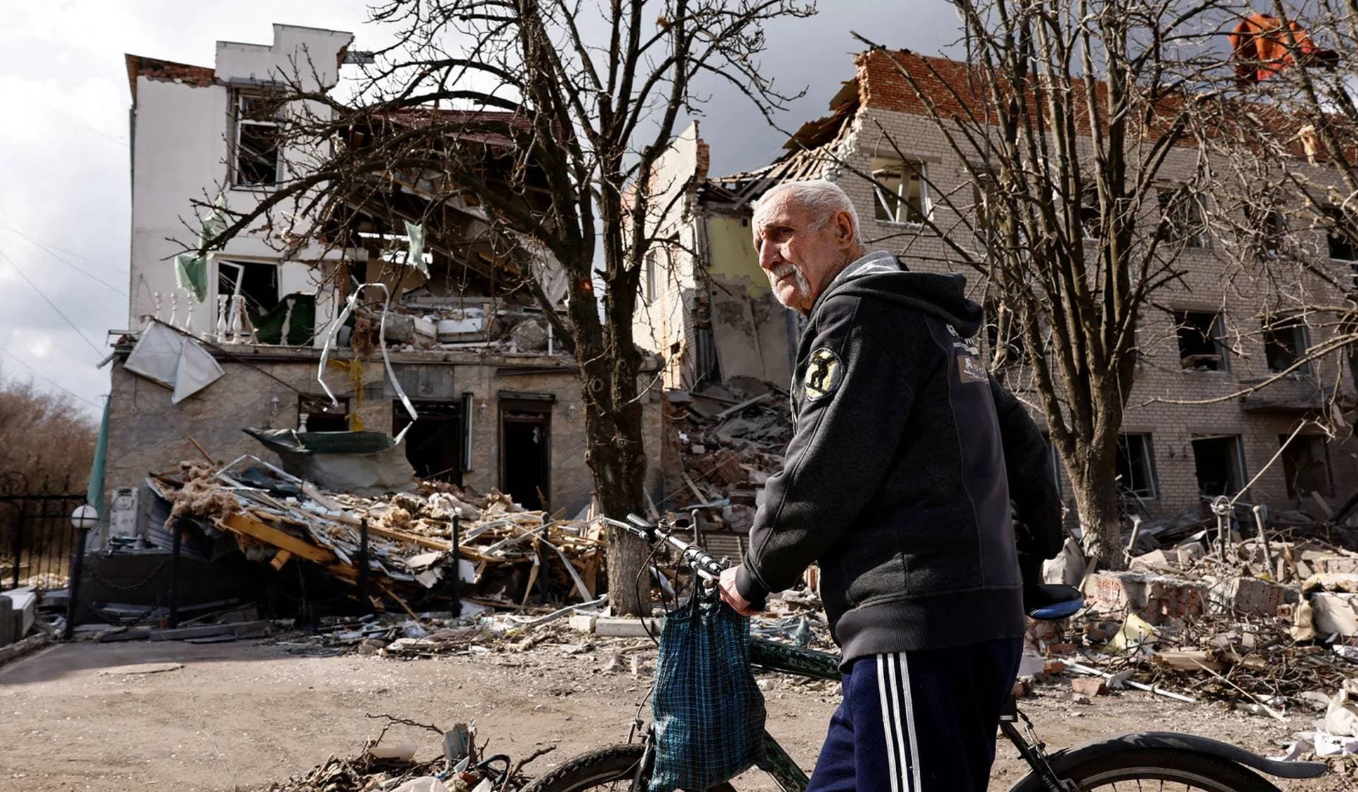 A man looks on in the aftermath of deadly shelling of an army office building in Sloviansk
