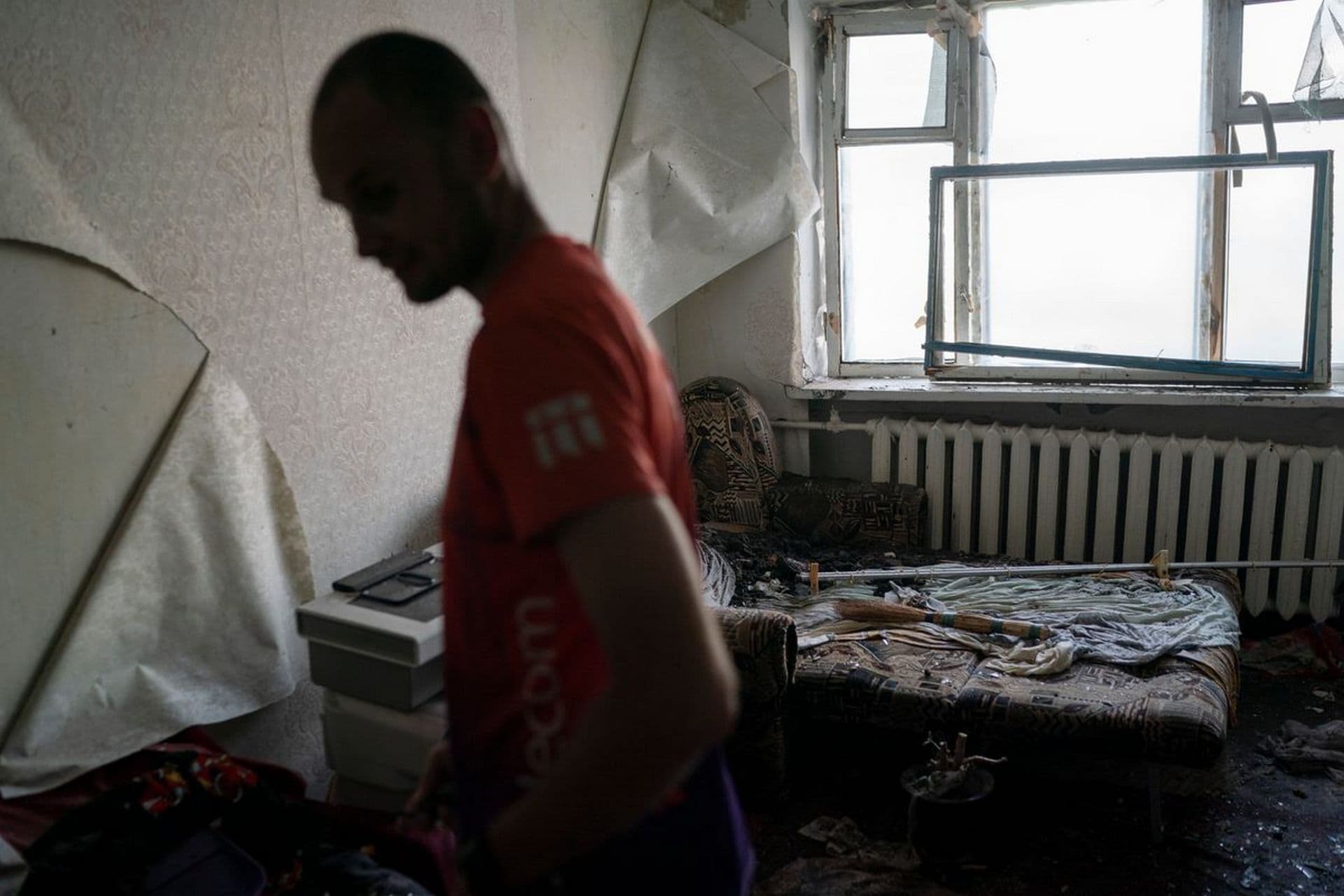 Kostiantyn Daineko, stands in his mother's apartment that was damaged after a Russian attack in Slovyansk