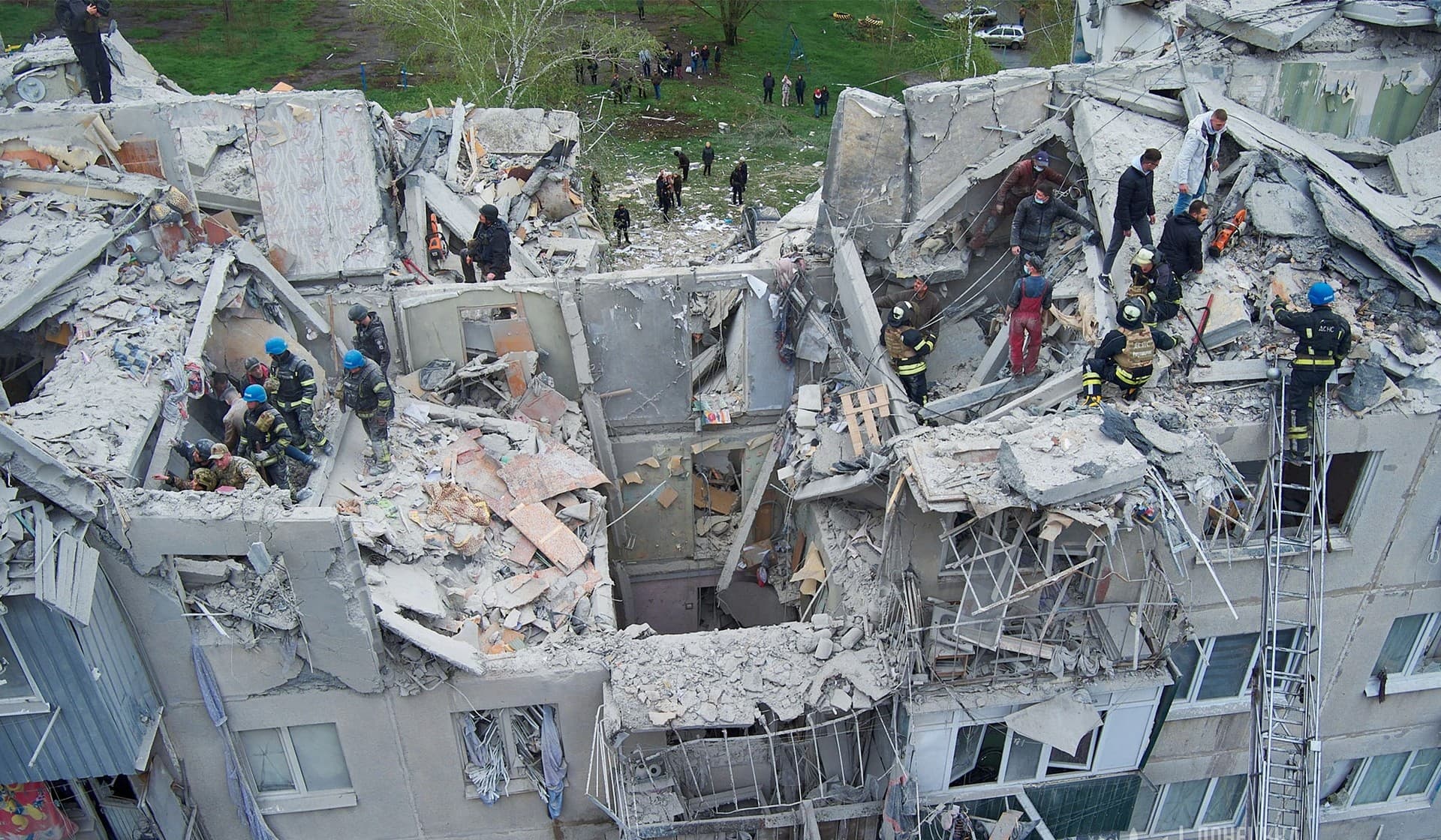 Rescuers work at a site of a residential building damaged by a Russian military strike in Sloviansk