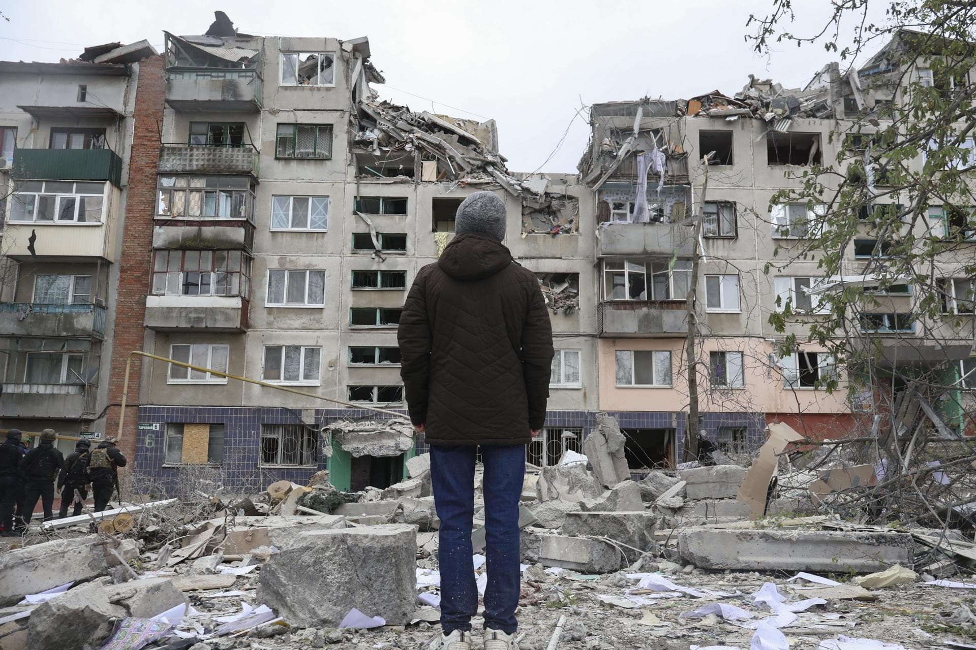 A local resident looks at his home, damaged by a Russian rocket attack in Sloviansk