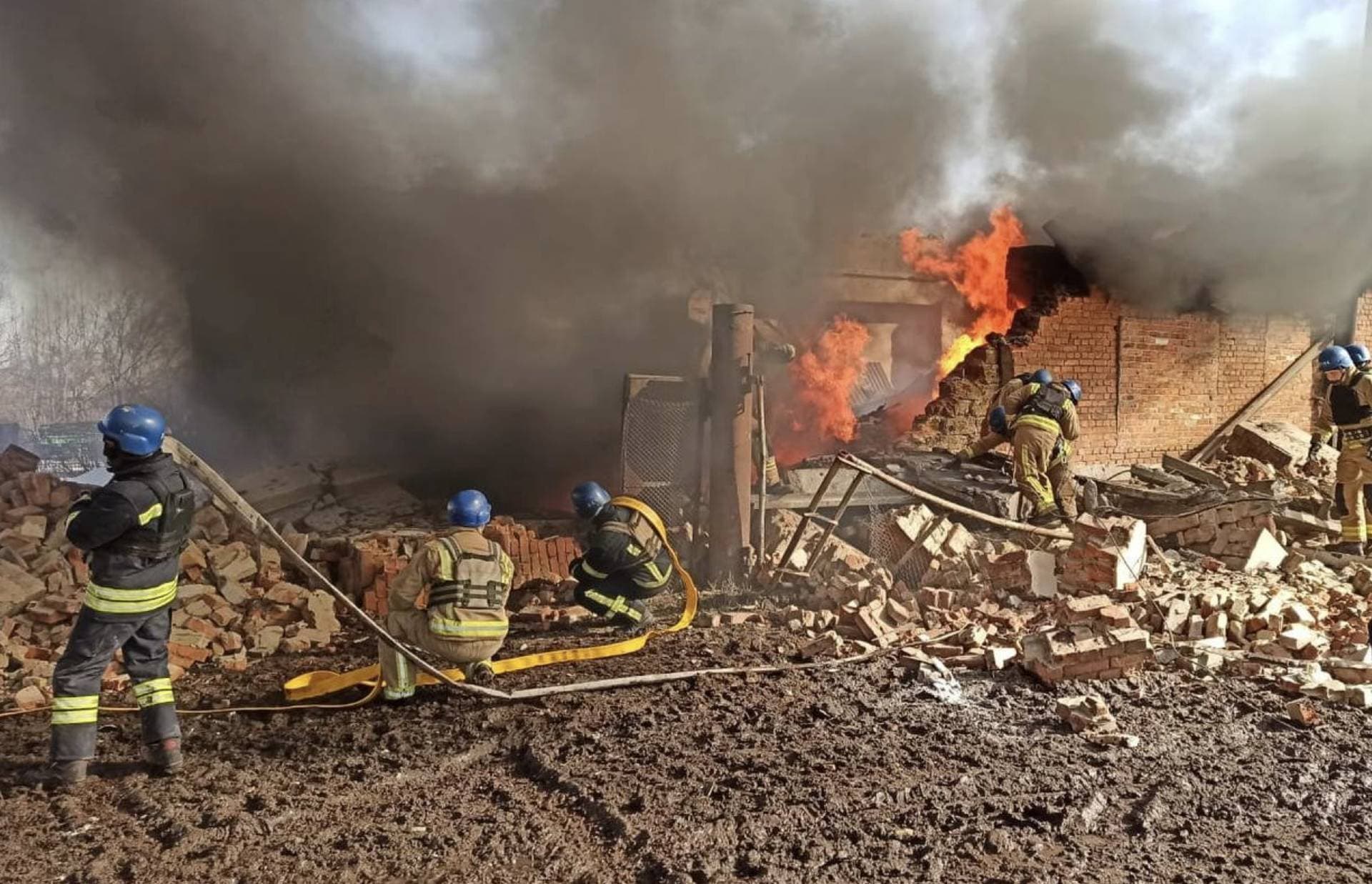 Rescuers work at the site of a Russian military strike in Sumy region