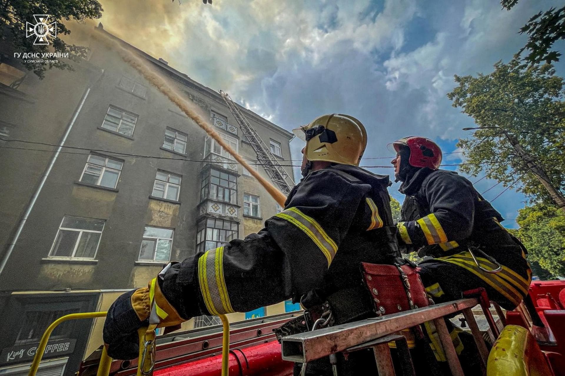 Firefighters work at a site of a residential building hit by a suicide drone in Sumy