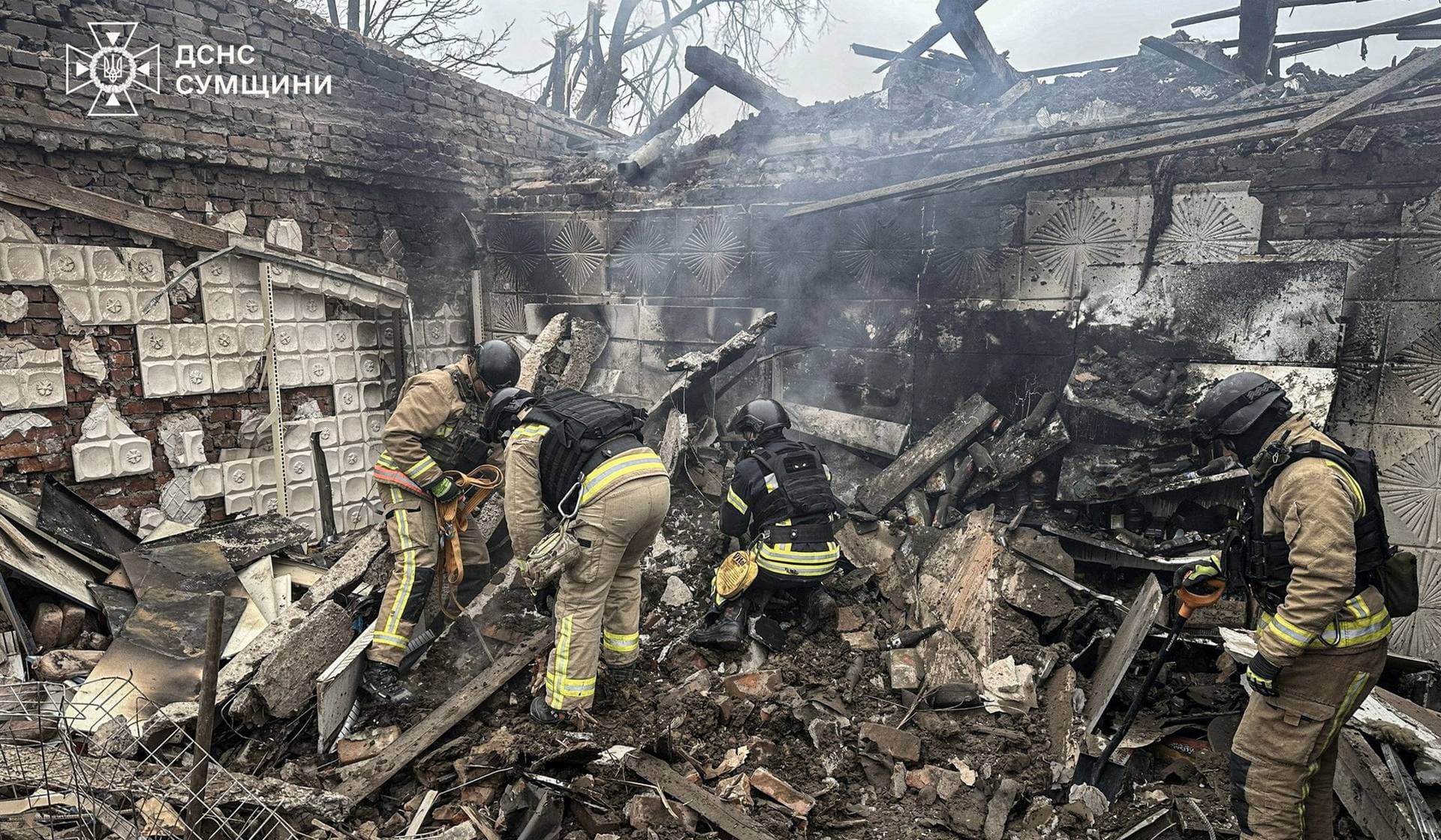 Rescuers work at the site where a store was hit by a Russian air strike in Sumy Region