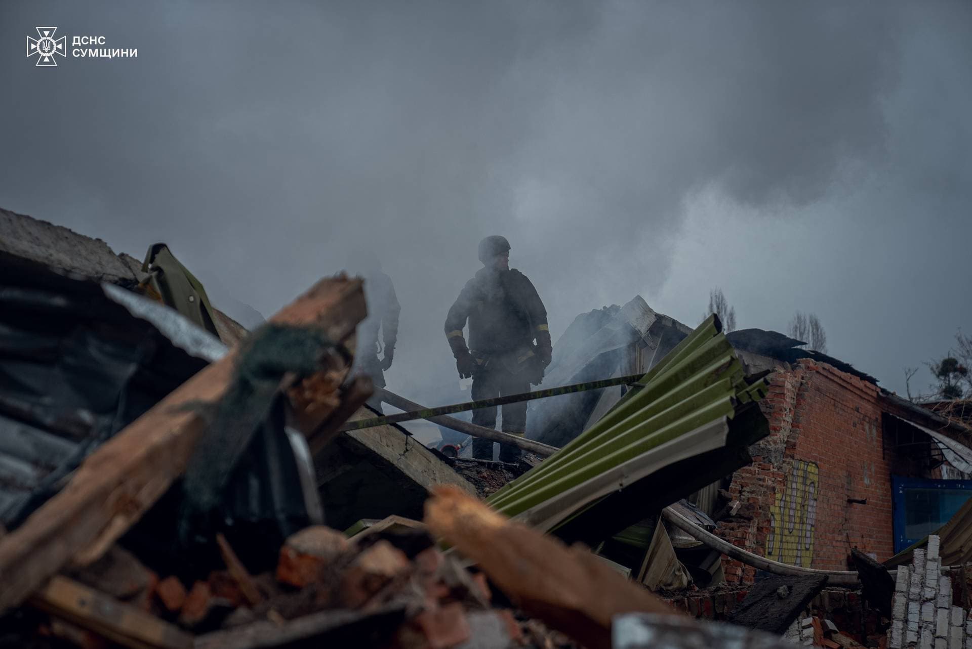Firefighters work at the site of a Russian military strike in Sumy