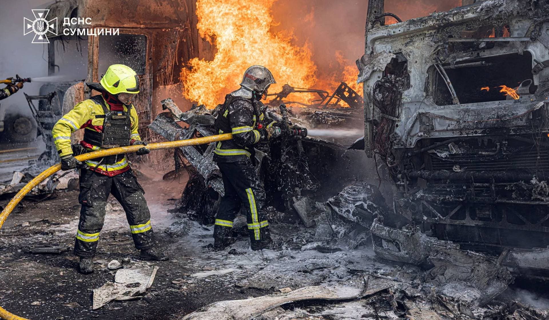 Firefighters work at the site of a Russian strike in Sumy