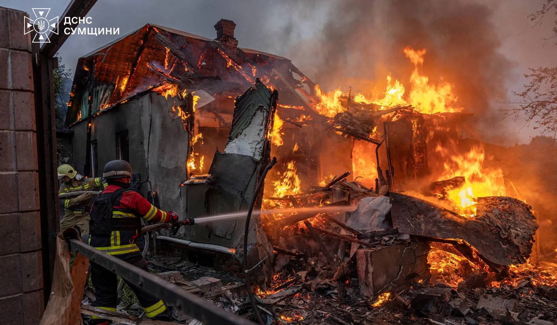 Firefighters work at the site of a private house hit during a Russian military strike in Sumy