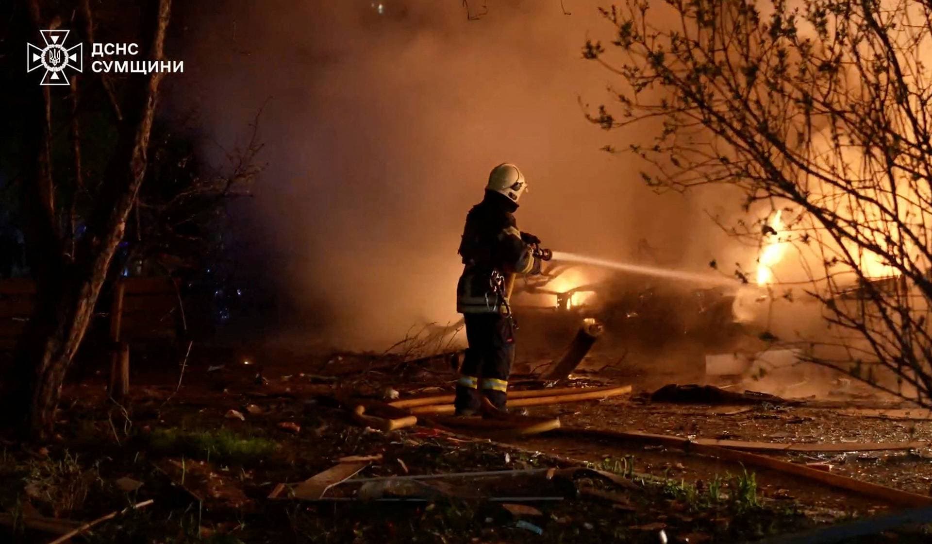 A firefighter works at a site of Russian strikes in Sumy