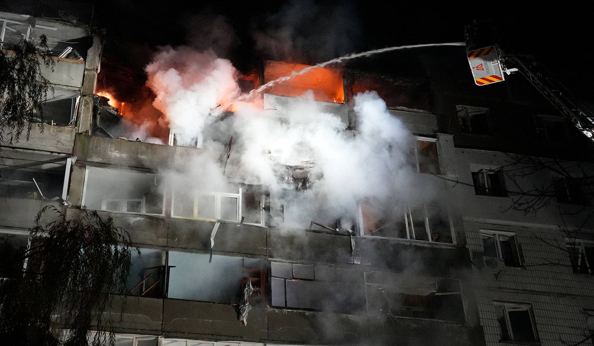 A firefighter works at the site of the apartment building hit during the Russian drone strike in Sumy