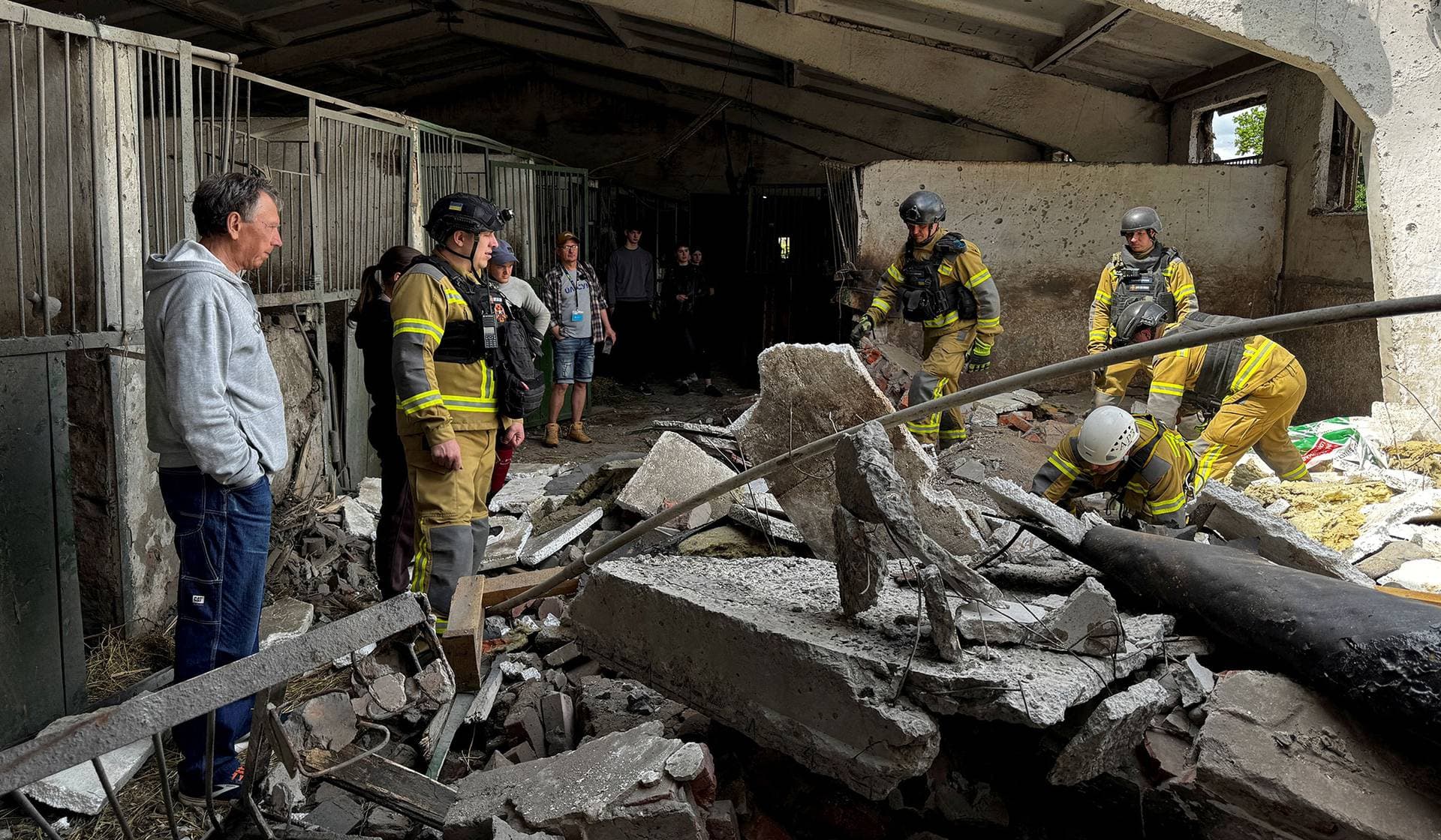 Rescuers work at a site of a Horse Sport Riding School hit by a Russian drone strike in Sumy, Ukraine, June 17, 2026. Picture taken with a mobile phone.