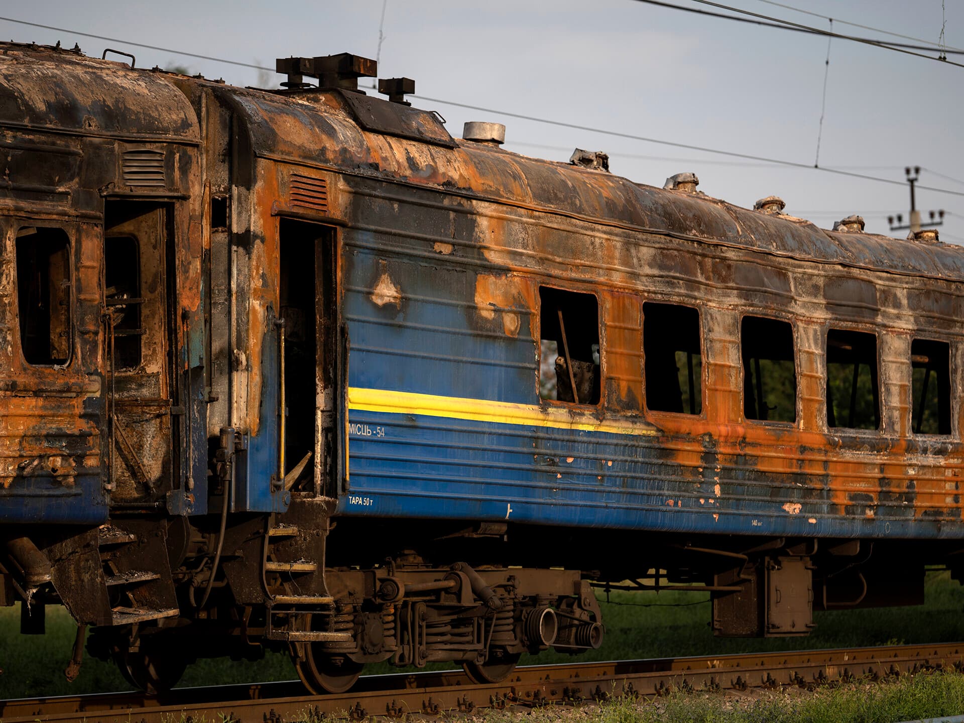 A heavily damaged train is seen at a train station after a Russian attack Wednesday during Ukraine's Independence Day in the village Chaplyne