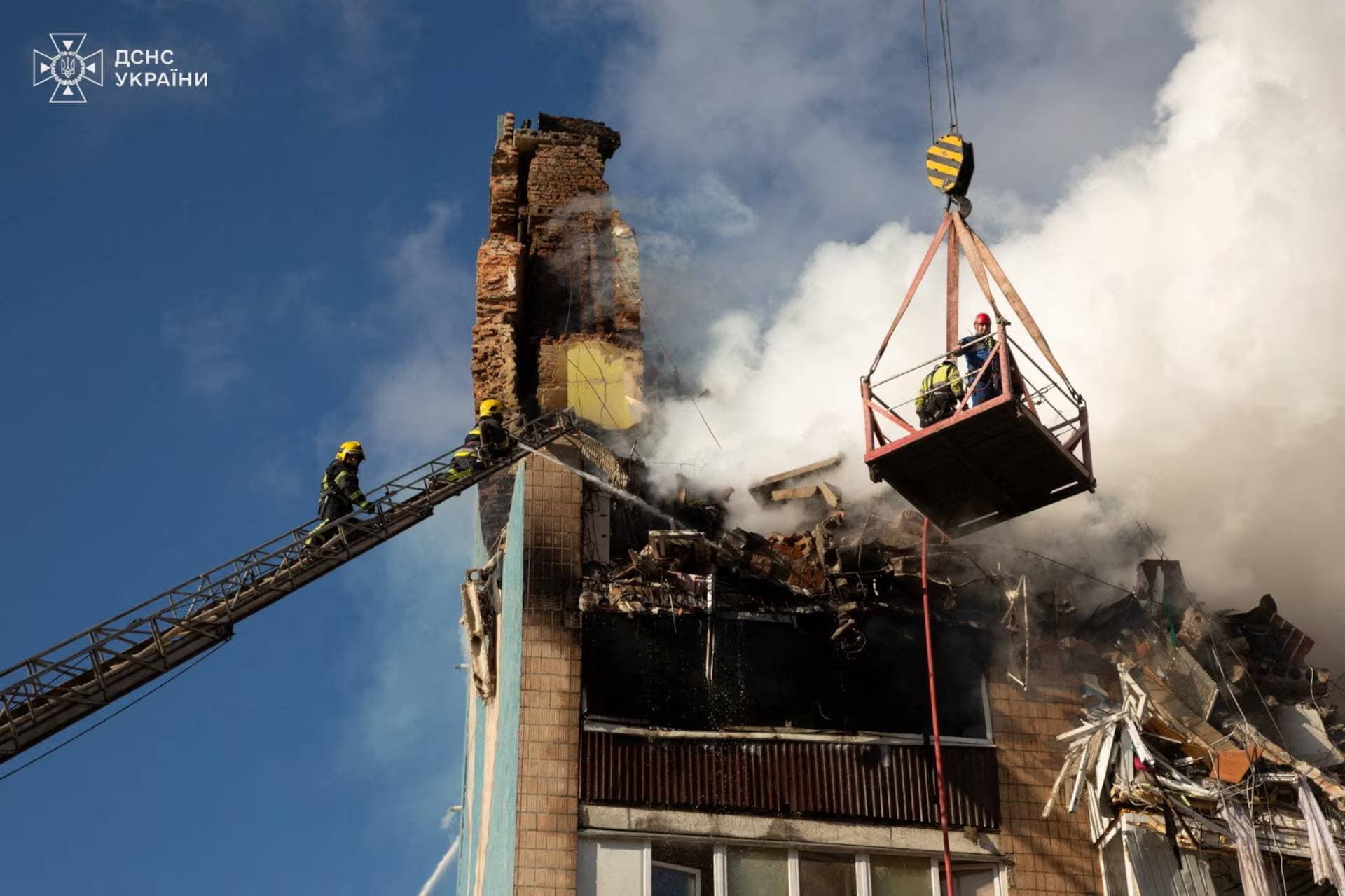 Firefighters work at the site of an apartment building hit by a morning Russian missile strike in Ternopil