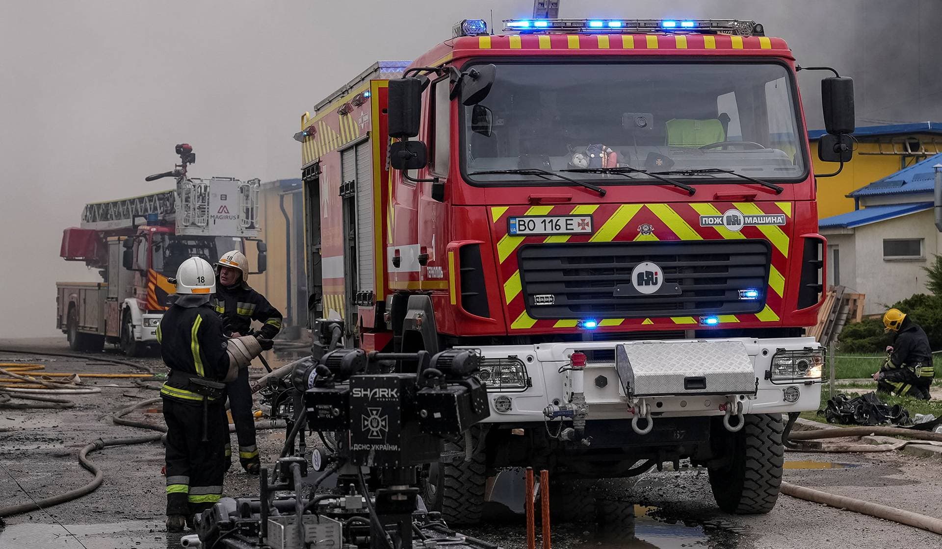 Rescuers work at a site of a Russian drone strike in Ternopil