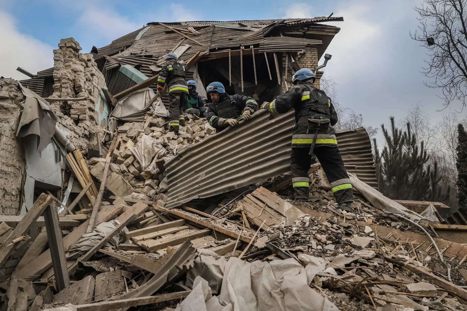 Ukrainian firefighters work at a damaged hospital maternity ward in Vilniansk
