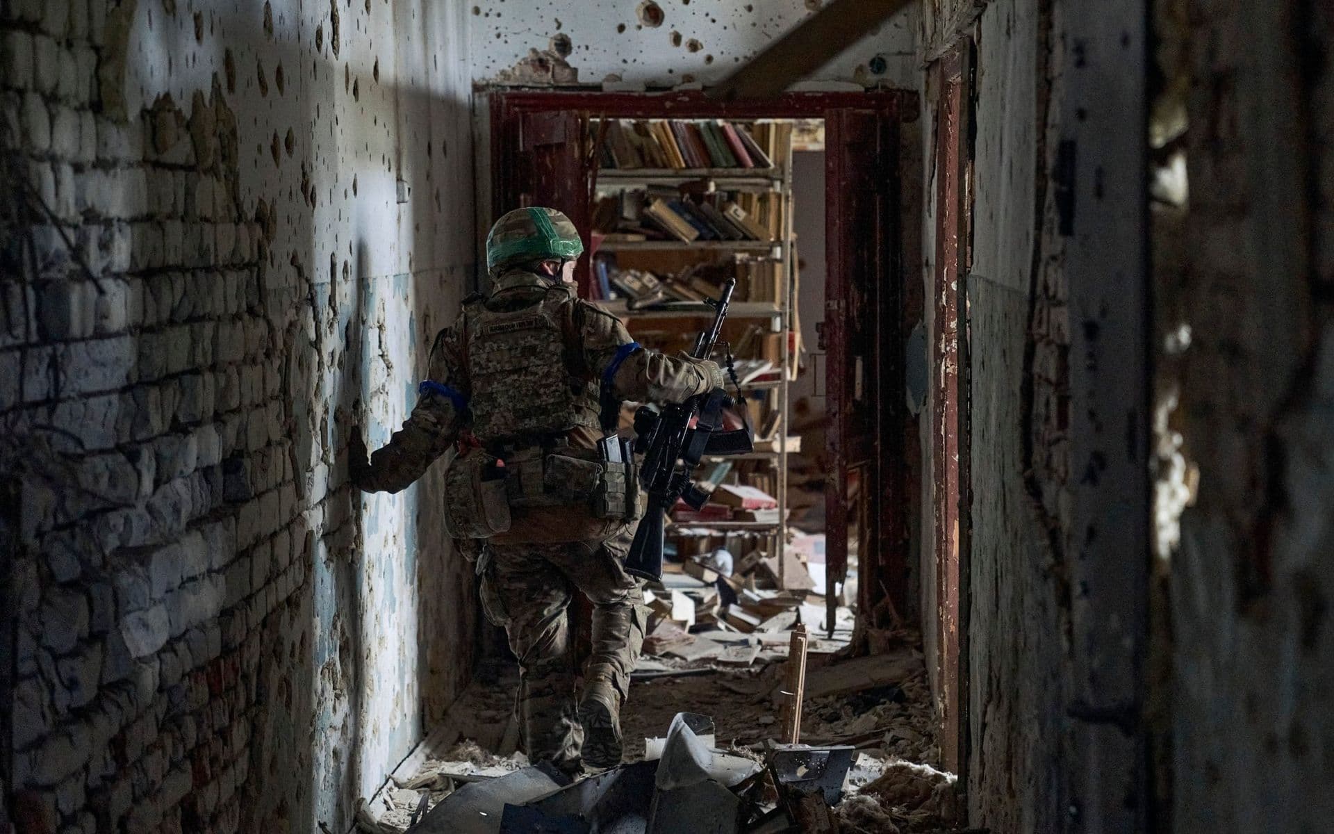 A Ukrainian soldier examines a cultural centre in recently retaken Blahodatne