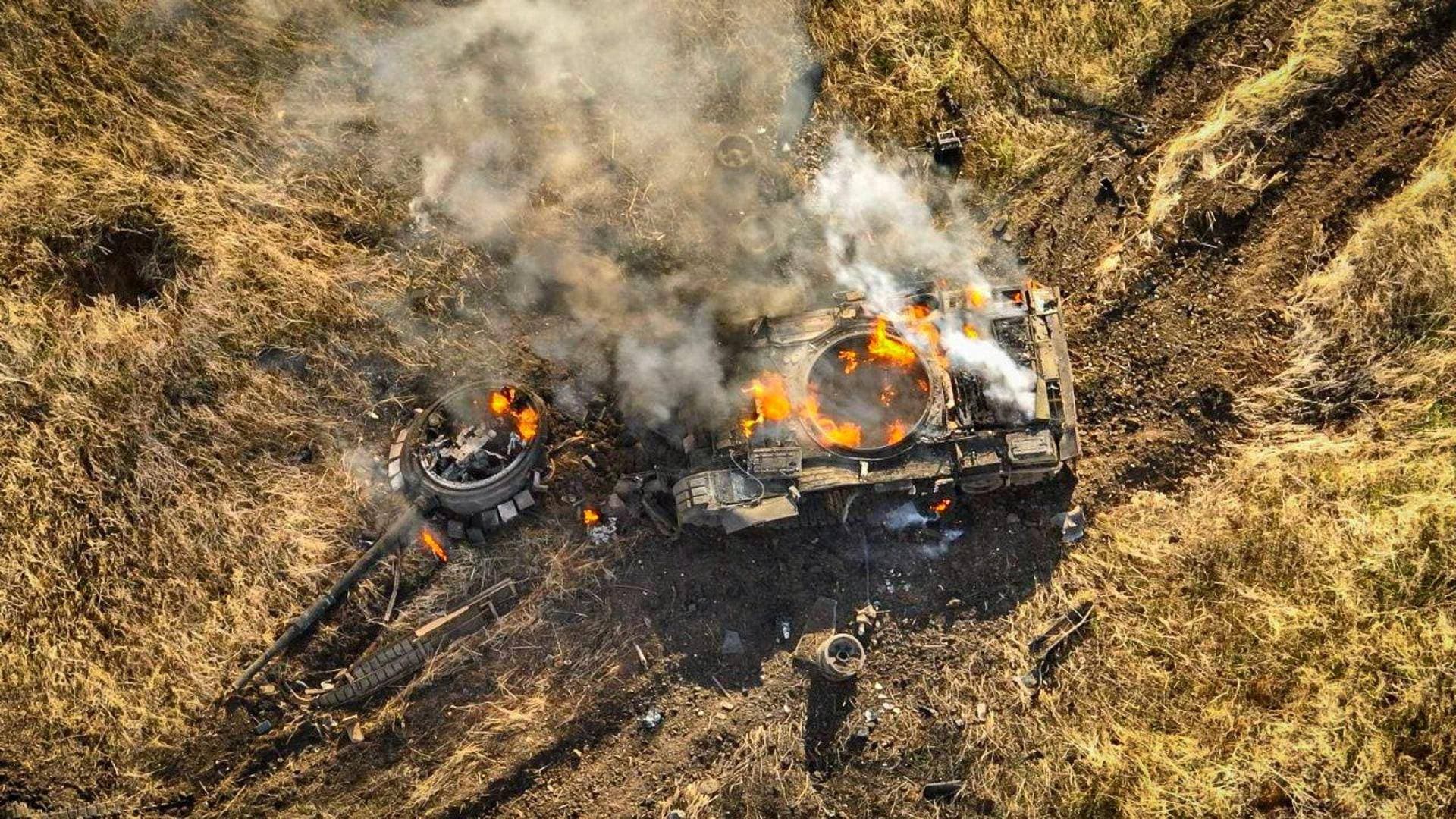 A Russian tank burns in a field near the town of Vuhledar