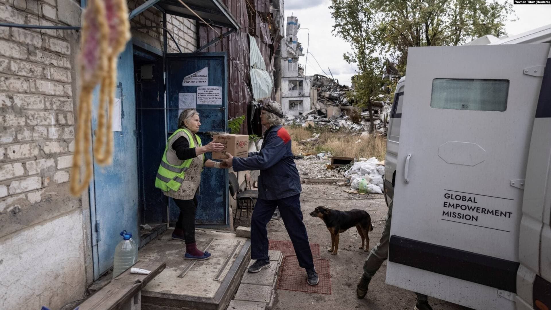 Volunteers unload humanitarian aid in the Ukrainian frontline city of Vuhledar