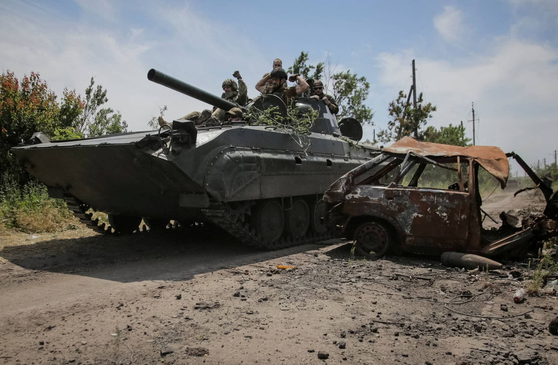 Ukrainian service members ride a BMP-1 infantry fighting vehicle near the front line in the newly liberated village Neskuchne in Donetsk region, Ukraine, June 13, 2023. 
