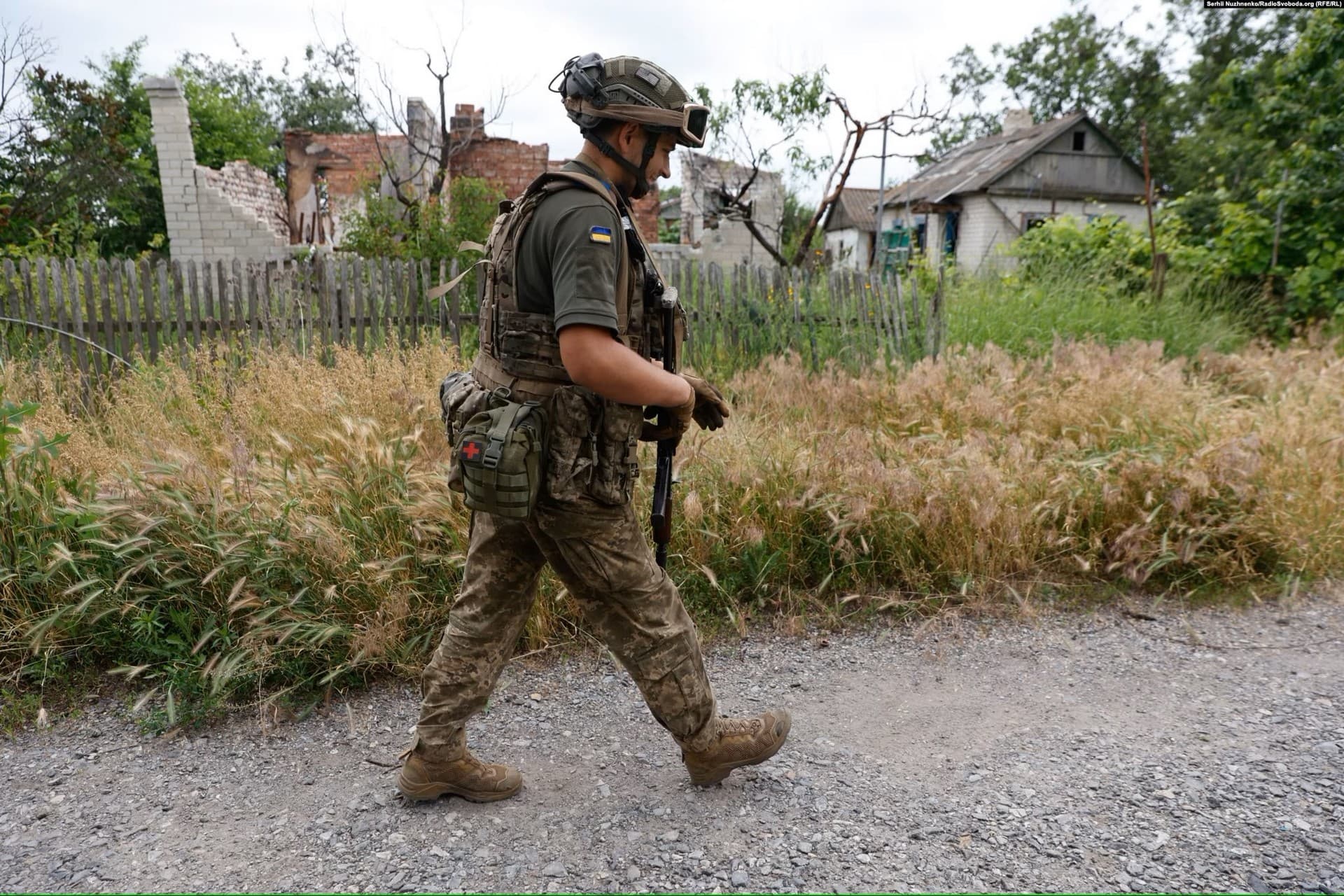 A Ukrainian soldier walks through Blahodatne
