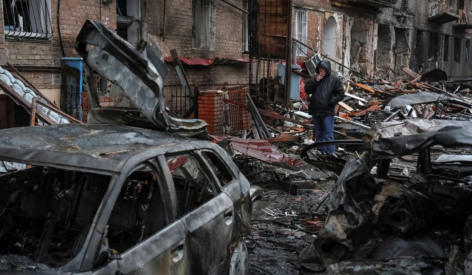 A local resident stands near his residential building destroyed by a Russian missile attack in the town of Vyshhorod